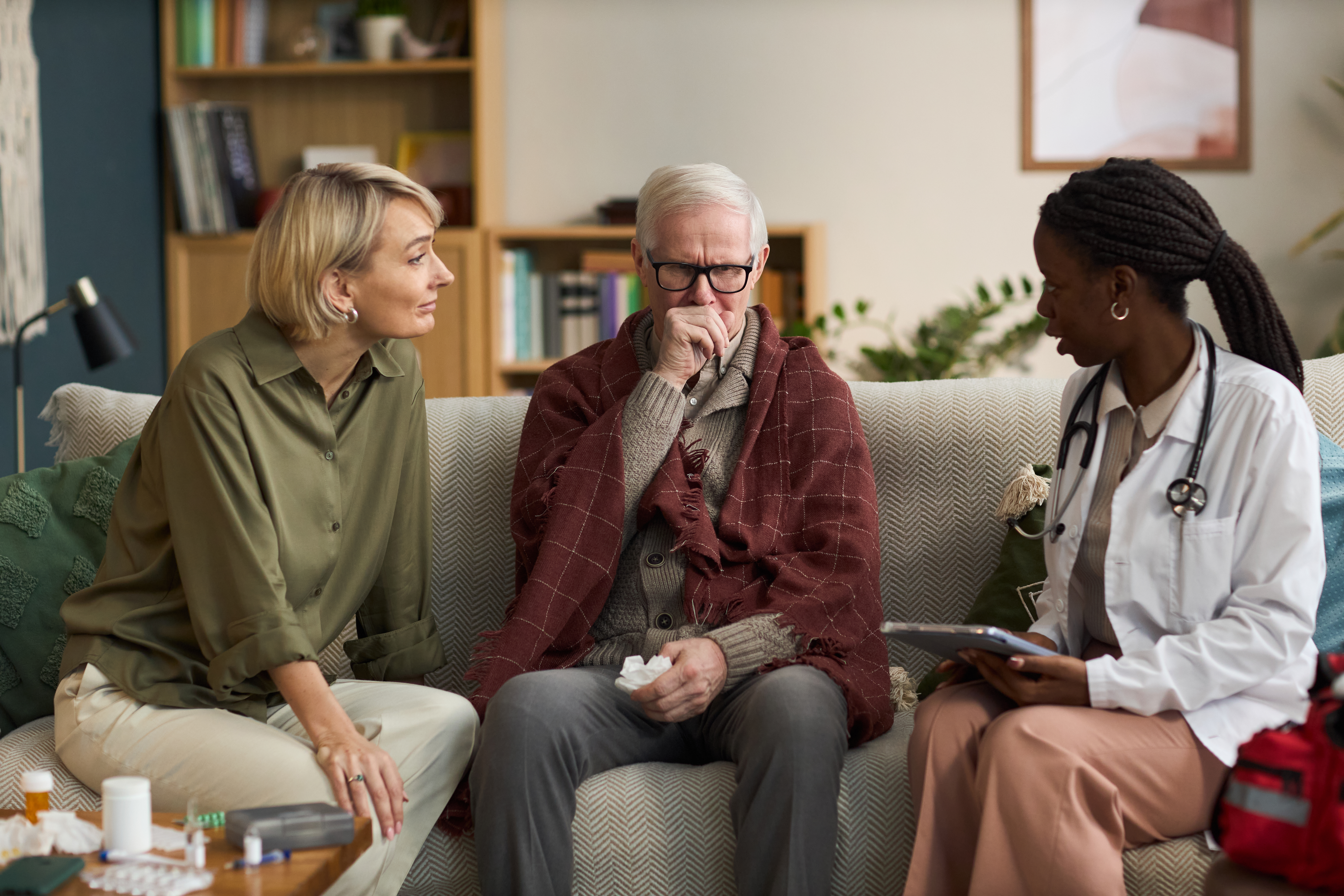 Doctor visiting senior patient at home
